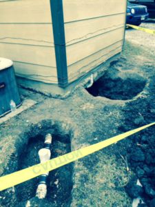 image of two holes showing exposed pipes
