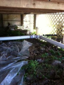 image of a pipe under a house