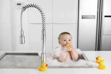 kitchen sink with a baby taking a bath