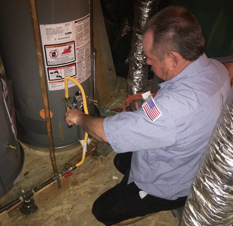 plumber checking a water heater