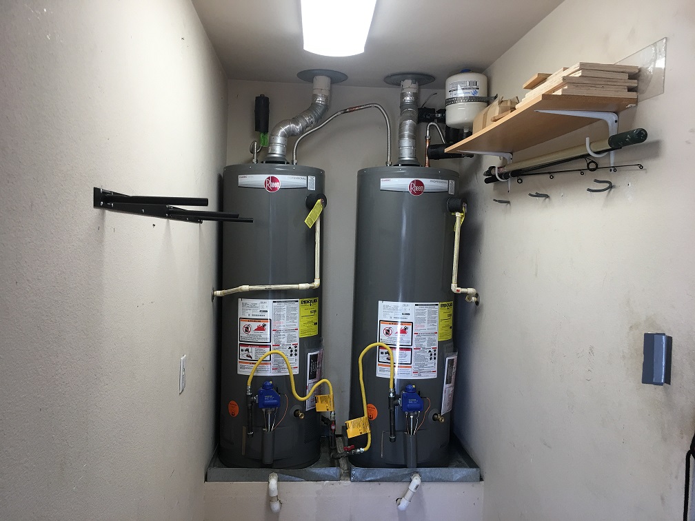 Two hot water heaters beside each other.