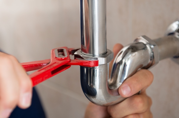 A plumber fixing a leak.