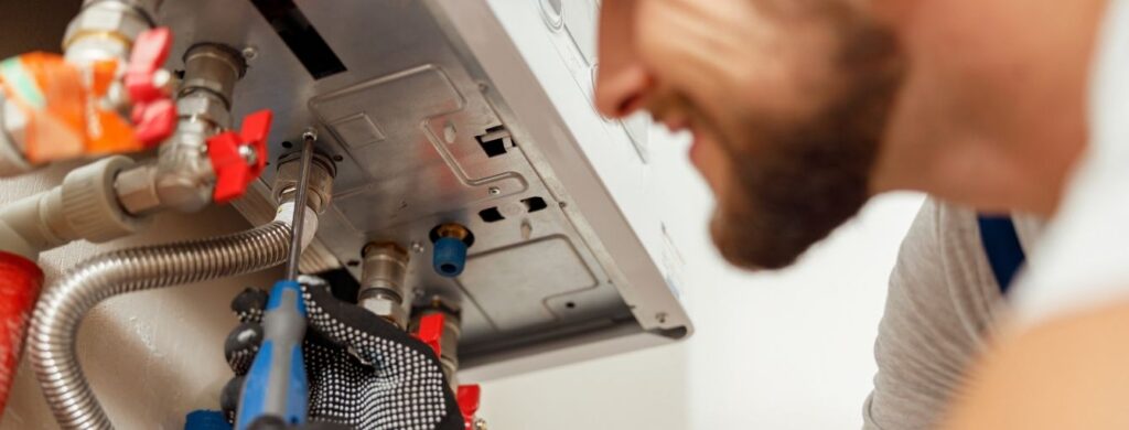 A plumber installing a tankless water heater. 