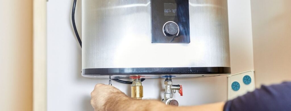 A plumber installing a water heater. 